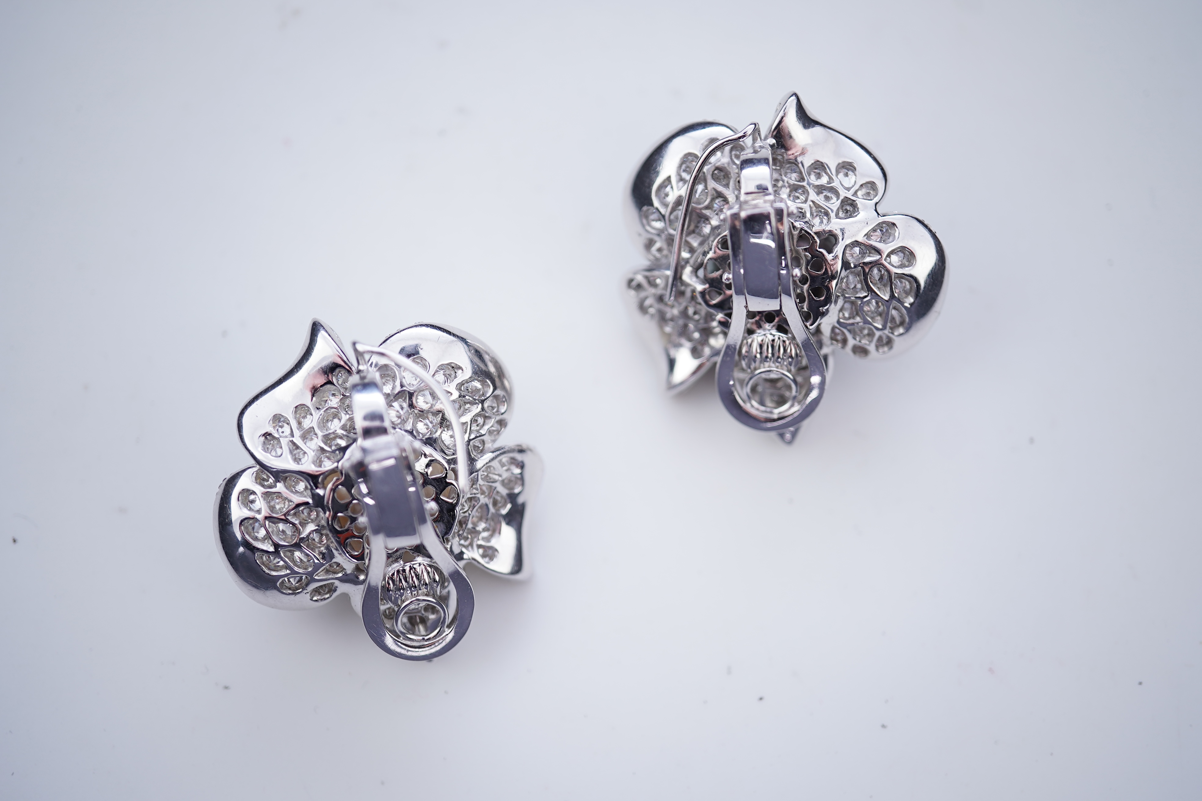 A pair of cultured pearl and diamond ear clips